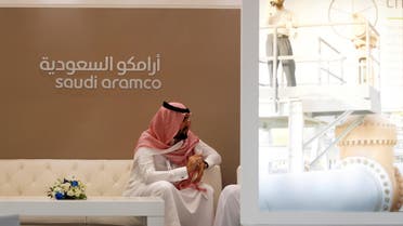 A Saudi Aramco employee sits in the area of its stand at the Middle East Petrotech 2016, an exhibition and conference for the refining and petrochemical industries, in Manama, Bahrain, September 27, 2016. REUTERS
