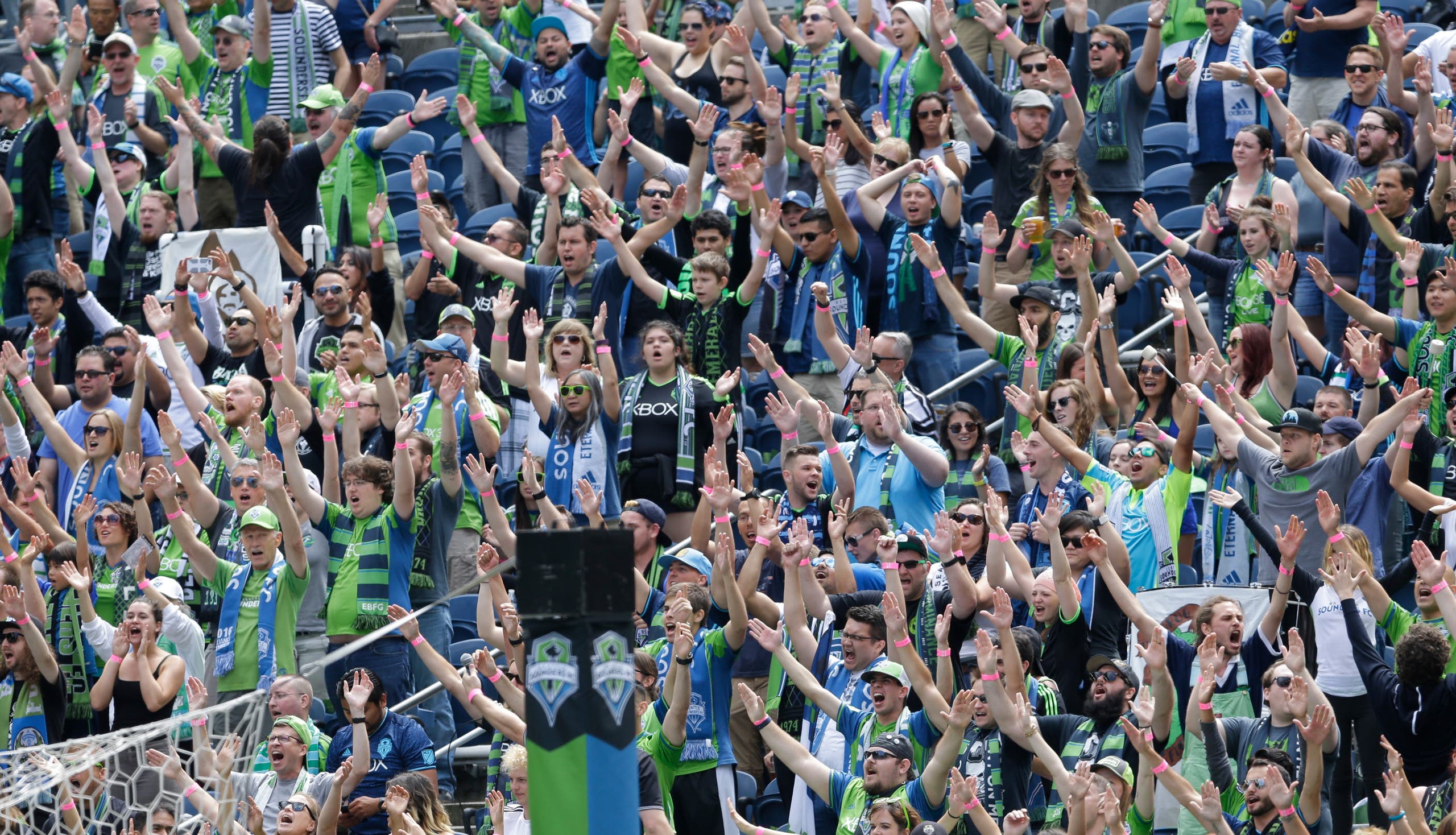 Members of the Emerald City Supporters and and other fans cheer at the start of an MLS soccer match against the Los Angeles Galaxy, Sunday, July 31, 2016, in Seattle. (AP)