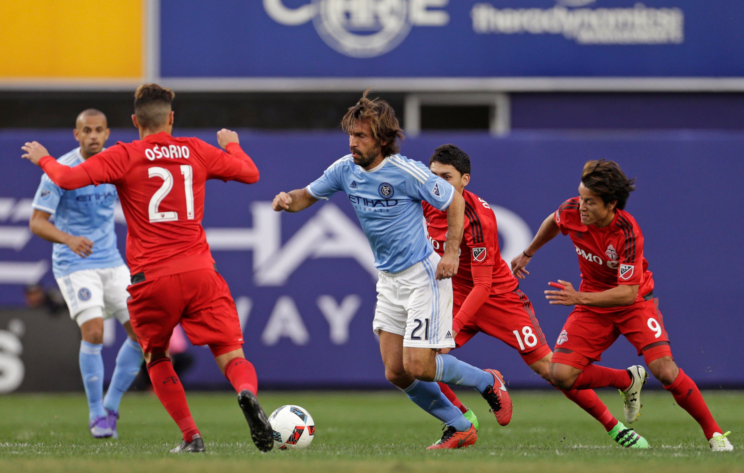New York City FC midfielder Andrea Pirlo (21) controls the ball in front of Toronto FC midfielder Jonathan Osorio (21) during the first half of an MLS soccer game at Yankee Stadium on Sunday, March 13, 2016, in New York. (AP)