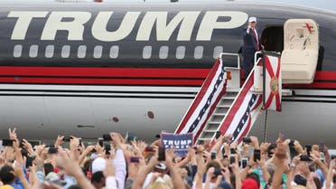 Republican presidential nominee Donald Trump pumps his fist to supporters at the conclusion of his campaign event on the tarmac at Lakeland Linder Regional Airport in Lakeland, Florida on October 12, 2016. (AFP)
