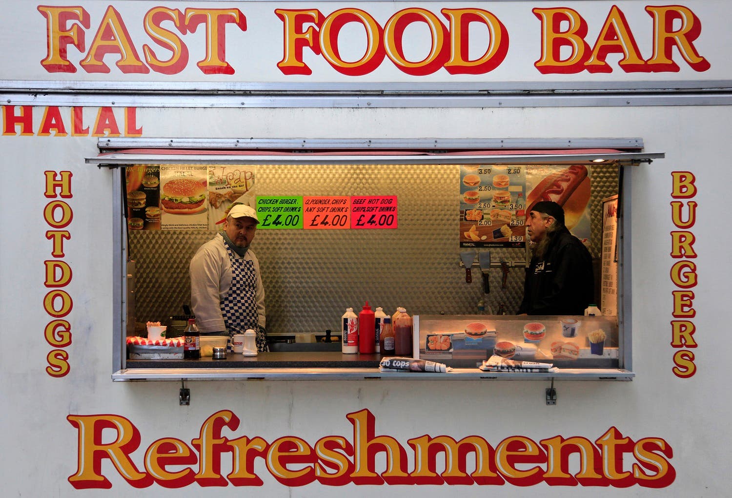 Workers wait for customers at their fast food outlet in London January 20, 2011. (Reuters)