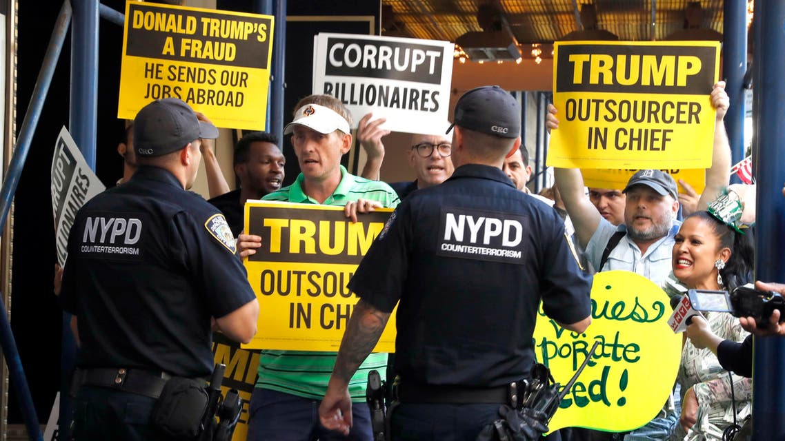Police talks to demonstrators protesting outside the Waldorf Astoria hotel in New York, Thursday, Sept. 15, 2016, where Republican Presidential candidate Donald Trump is attending a luncheon. (AP)