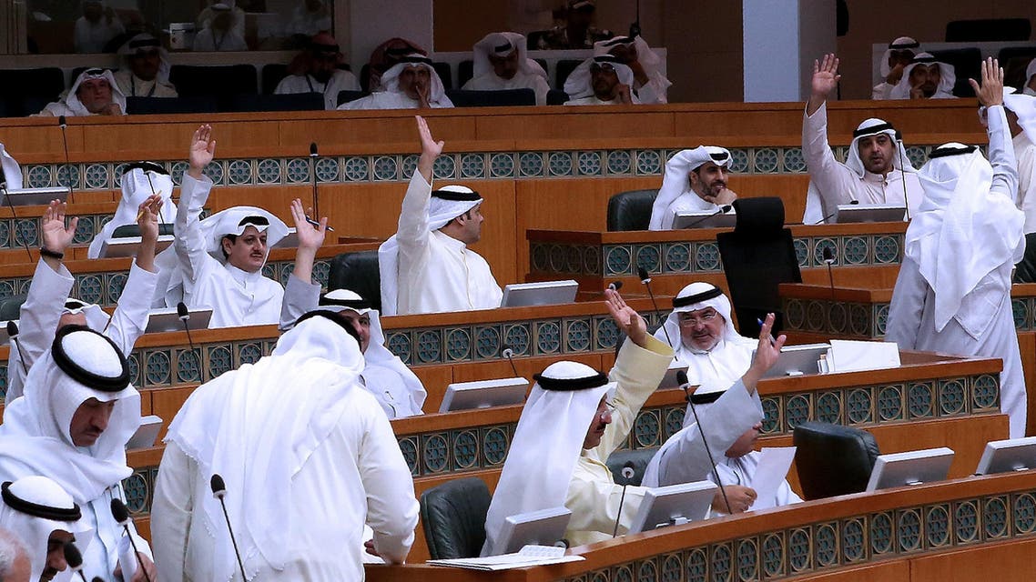 Kuwaiti MPs raise their hands as they vote during a parliament session at the Kuwait's national assembly in Kuwait City on July 3, 2016. AFP
