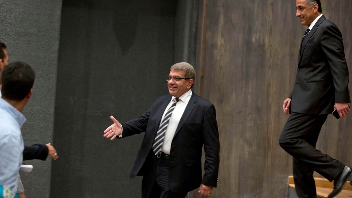 Egyptian Minister of Finance Amr El-Garhy (left), and Central Bank Governor Tarek Amer greet reporters before a press conference at the headquarters of the finance ministry in Cairo, Egypt, on Thursday, August 11, 2016. (AP)