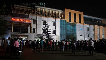 People gather outside the private Sum Hospital after a fire broke out in its intensive care unit, in Bhubaneswar, in the eastern Indian state of Orissa, Monday, Oct. 17, 2016. (AP)