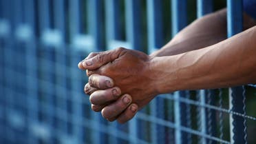 prison bars hands shutterstock