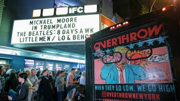 People wait in line outside the IFC Theater before the debut of a surprise documentary about Republican nominee Donald Trump titled "TrumpLand" by US filmmaker Michael Moore in New York on October 18, 2016. KENA BETANCUR / AFP