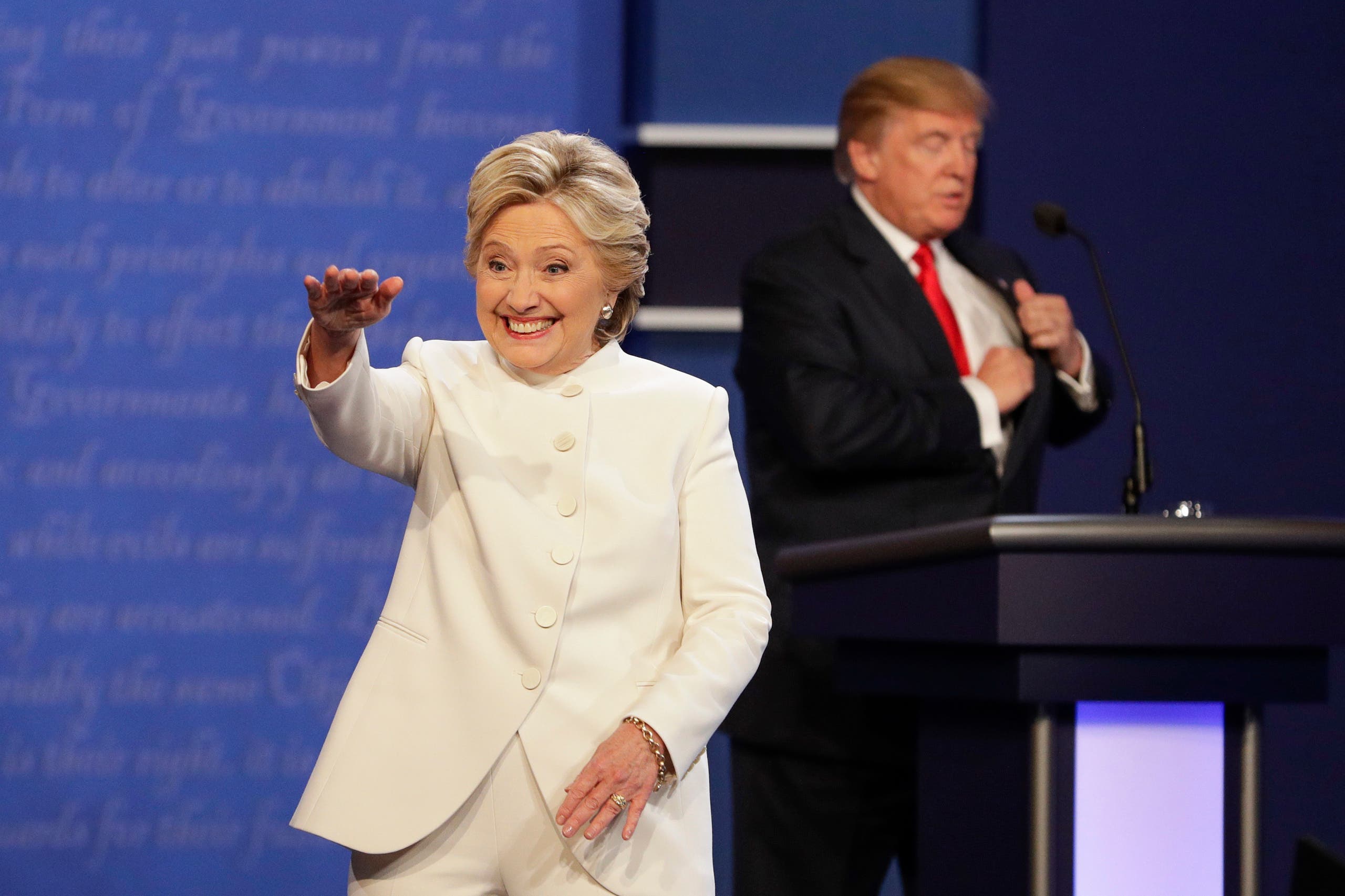 Democratic presidential nominee Hillary Clinton waves to the audience as Republican presidential nominee Donald Trump puts away his notes after the third presidential debate at UNLV in Las Vegas, Wednesday, Oct. 19, 2016. (AP 