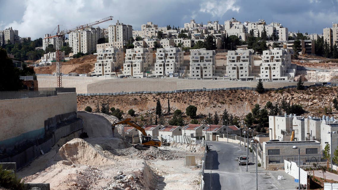 A general view taken on September 23, 2016 shows Israeli construction cranes and excavators at a building site of new housing units in the Jewish settlement of Neve Yaakov, in the northern area of east Jerusalem. AHMAD GHARABLI / AFP