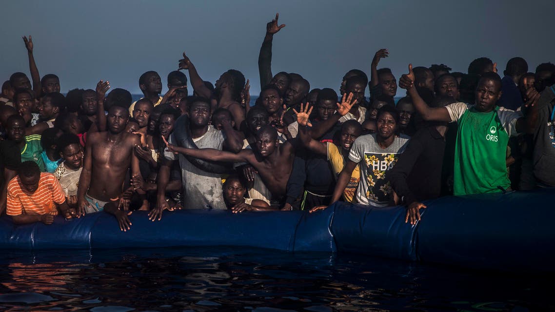 In this photo taken on Saturday Sept. 10, 2016, African refugees and migrants react aboard a partially punctured rubber boat as they wait to be assisted by a NGO, non-governmental organization members, during a rescue operation on the Mediterranean Sea, about 13 miles North of Sabratha, Lybia, (AP Photo/Santi Palacios)