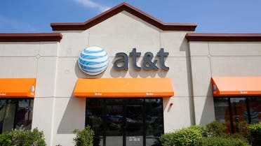 In this Wednesday, May 14, 2014 photo an AT&T logo is attached to the exterior of a store location in Dedham, Mass. (AP)