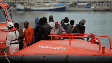 Migrants, who are part of a group intercepted aboard a dinghy off the coast in the Mediterranean sea, stand on a rescue boat upon arriving at a port in Malaga, southern Spain, October 22, 2016. REUTERS