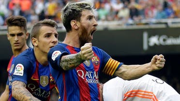 FC Barcelona's Lionel Messi celebrates after scoring a penalty during the Spanish La Liga soccer match between Valencia and FC Barcelona at the Mestalla stadium in Valencia, Spain, Saturday, Oct. 22, 2016. (AP 