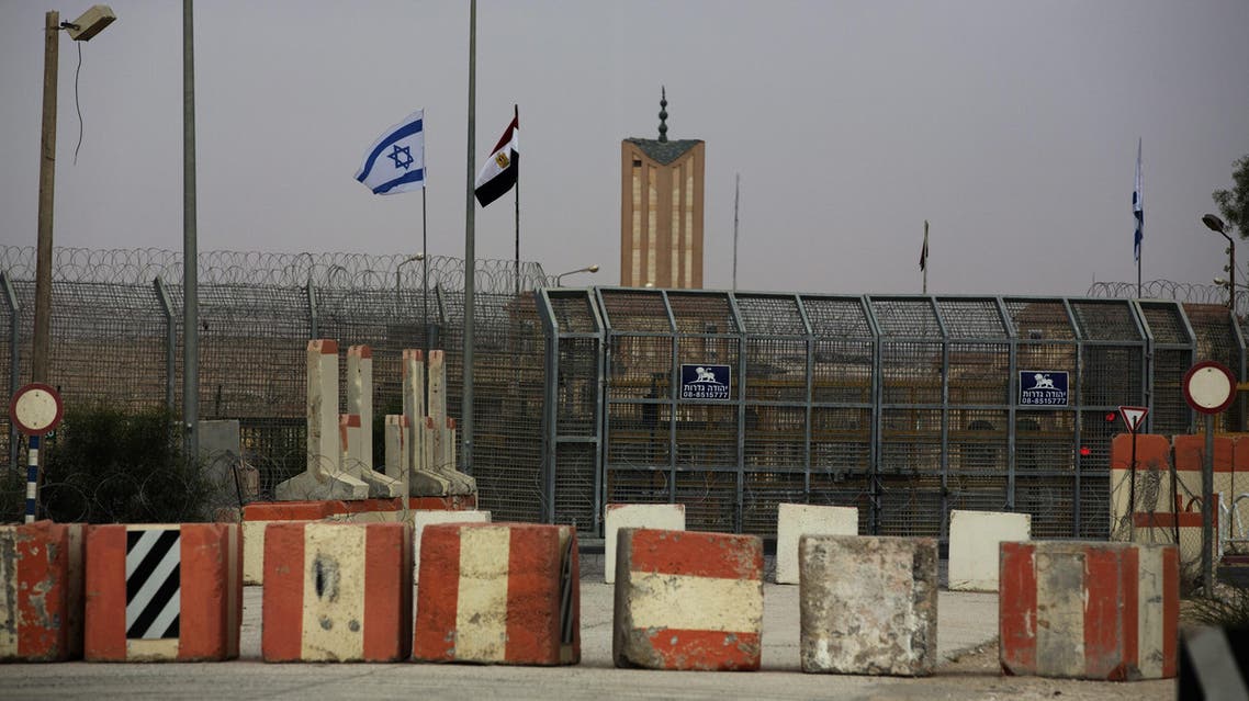 Israeli and Egyptian flags are seen in the Nitzana Border Crossing along the southern Israeli border with Egypt near the Israeli village of Nitzanei Sinai on August 20 2013. 