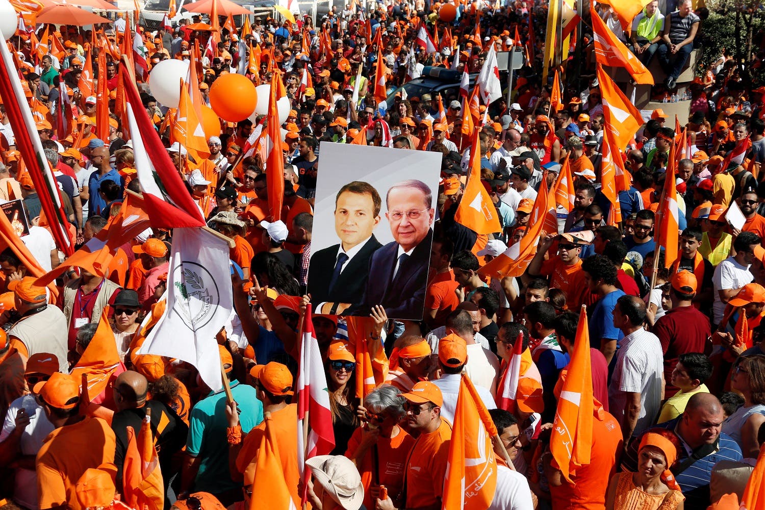 Supporters of the Free Patriotic Movement (FPM) carry flags and a picture of Christian politician and FPM founder Michel Aoun in October 2016. (File photo: Reuters)