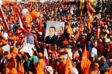Supporters of the Free Patriotic Movement (FPM) carry flags and a picture of Christian politician and FPM founder Michel Aoun. (Reuters)