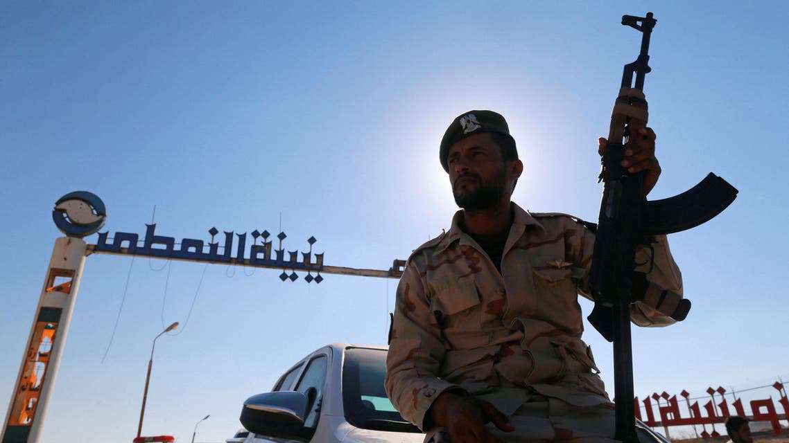 A member of Libyan forces loyal to eastern commander Khalifa Haftar holds a weapon as he sits on a car in front of the gate at Zueitina oil terminal in Zueitina, west of Benghazi, Libya September 14, 2016. Picture taken September 14, 2016. REUTERS