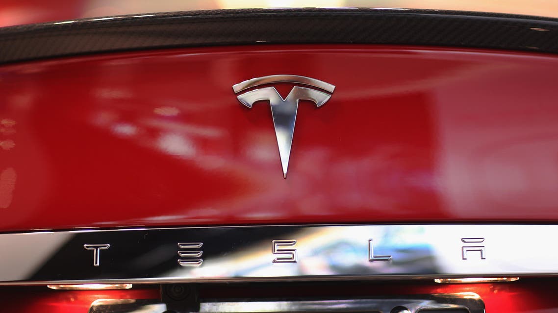 A Tesla motor company car logo sits on a car in a dealership at the Dadeland Mall on June 6, 2013 in Miami, Florida. The electric car maker is trying to make a move by selling their cars, that can cost between $62,400 and $82,400, into malls and stores. Joe Raedle/Getty Images/AFP