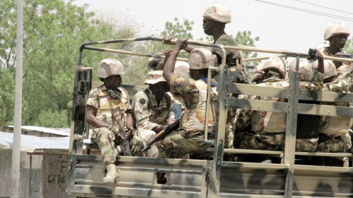 Soldiers are seen on a truck in Maiduguri in Borno State, Nigeria May 14, 2015. At least six civilians and six members of a youth vigilante group were killed in an attack by Boko Haram militants on Nigeria's northeastern city Maiduguri, two military sources said on Thursday. REUTERS
