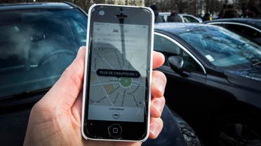 (FILES) This file photo taken on February 9, 2016 in Paris shows a smartphone displaying the app for ride service Uber with a box reading "No more drivers", as Uber suspends the app from 11am to 3pm in support of protesting non-licensed private hire cab drivers. Uber drivers in France express grievances against the US-based transport company Uber, such as degraded working conditions, low financial viability and the increasing risk of accidents. In an attempt to regulate the sector, a bill, already passed by the Parliament, will be examined in the French Senate on November 2, 2016. AFP