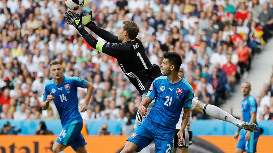 Germany goalkeeper Manuel Neuer reaches for the ball ahead of Slovakia's Michal Duris during the Euro 2016 round of 16 soccer match between Germany and Slovakia, at the Pierre Mauroy stadium in Villeneuve d'Ascq, near Lille, France, Sunday, June 26, 2016. (AP)