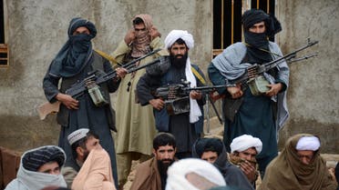 Afghan Taliban fighters listen to Mullah Mohammed Rasool, unseen, the newly-elected leader of a breakaway faction of the Taliban, in Farah province, Afghanistan. AP