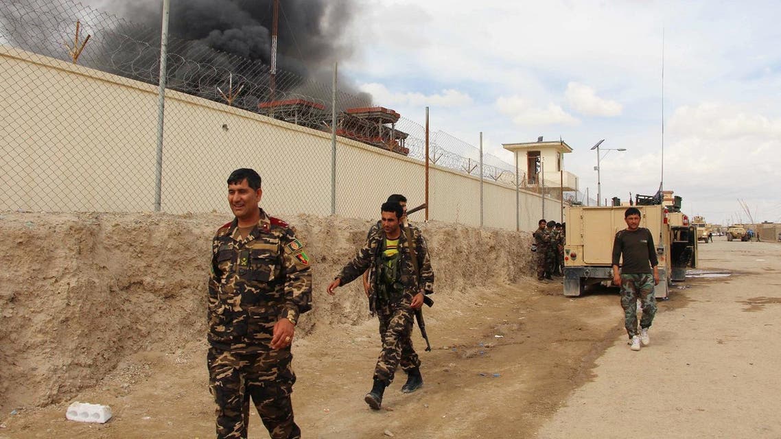 In this March 9, 2016 file photo, smoke rises from a building, where Taliban insurgents hide during a fire fight with Afghan security forces, in Helmand province, Afghanistan. For the past month, the Taliban have held control over most of Afghanistan’s Helmand province, where the majority of the world’s opium is grown -- and as insurgent attacks intensify around the provincial capital, residents are blaming rampant government corruption for the rising militant threat. At an international aid conference in Brussels that closed Wednesday, Oct. 5, 2016, Afghanistan’s leaders pledged to clamp down on graft, but corrupt officials have hollowed out national security forces and are alienating local populations. (AP Photo, File)