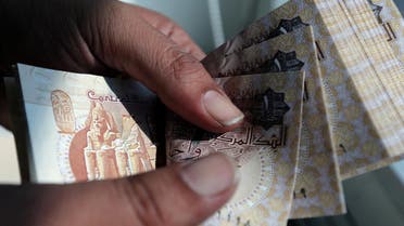 A man counts Egyptian pounds outside a bank in Cairo, Egypt October 24, 2016. reuters