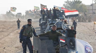Iraqi Federal Police officers observe as air and ground strikes hit the town of Shura, some 30 kilometers south of Mosul, Iraq, Saturday, Oct. 29, 2016. Iraqi troops approaching Mosul from the south advanced into Shura on Saturday after a wave of US led airstrikes and artillery shelling against Islamic State positions inside town. (AP)