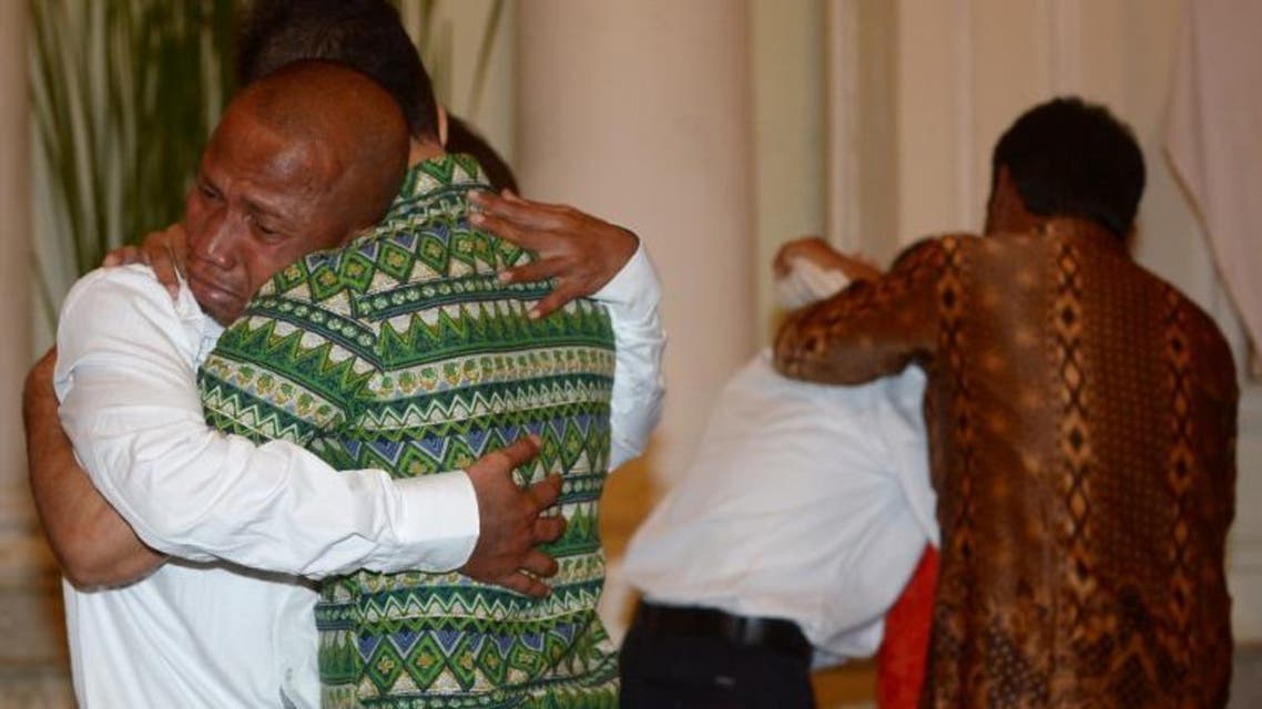 Elson Pesireron (L) hugs his brother Sammy as he and other freed Indonesian sailors who were held hostage for nearly five years by Somali pirates reunite with family members at the Foreign Ministry office in Jakarta on October 31, 2016. afp
