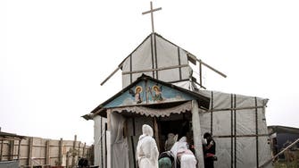 Young Calais migrants pray in “Jungle” church before demolition