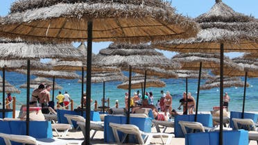 Tourists sunbathe at the Mediterranean resort of Sousse, Tunisa, four days after Friday's terrorist attack, Tuesday, June 30, 2015. One of Tunisia's top security officials says the gunman who killed 38 tourists, mostly Britons, in a beach attack was trained in neighboring Libya at the same time as the attackers who targeted the Bardo museum in March. (AP)