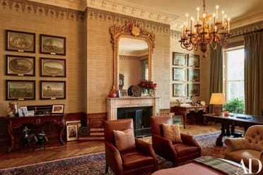 This image provided by Architectural Digest shows The Treaty Room in the White House in Washington in August 2016. The Treaty Room is filled with memorabilia including one of President Barack Obama's two Grammy Awards, family photos, and a personalized football. It’s also where Obama often retreats late at night. He uses the room’s namesake table, which has been in the White House since 1869, as a desk. Obama likes to say the White House is the “people’s house.” The Architectural Digest photos are giving the public its first glimpse of private areas on the second floor of the White House that Obama, his wife, Michelle, daughters Malia and Sasha and family dogs Bo and Sunny have called home for nearly eight years.(Michael Mundy/Architectural Digest via AP)