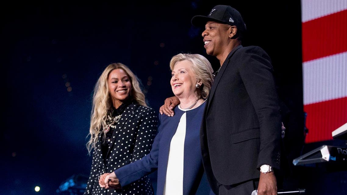 AP Democratic presidential candidate Hillary Clinton, center, appears on stage with artists Jay Z, right, and Beyonce, left, during a free concert at at the Wolstein Center in Cleveland, Friday, Nov. 4, 2016. 