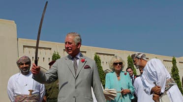 Britain's Prince Charles dances with a sword with a group of Omani traditional dancers in Muscat, Oman. (AP)