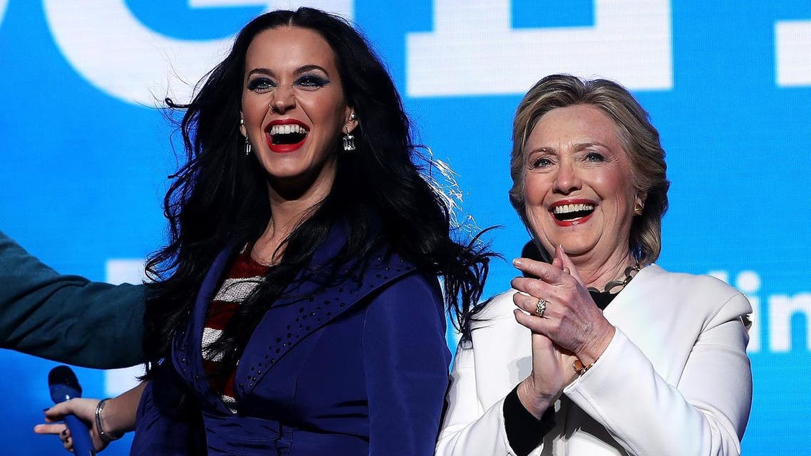 Democratic presidential nominee former Secretary of State Hillary Clinton (R) appears on stage with recording artist Katy Perry (L) during a get-out-the-vote concert at the Mann Center for the Performing Arts on November 5, 2016 in Philadelphia, Pennsylvania. (AFP)