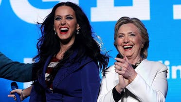 Democratic presidential nominee former Secretary of State Hillary Clinton (R) appears on stage with recording artist Katy Perry (L) during a get-out-the-vote concert at the Mann Center for the Performing Arts on November 5, 2016 in Philadelphia, Pennsylvania. (AFP)