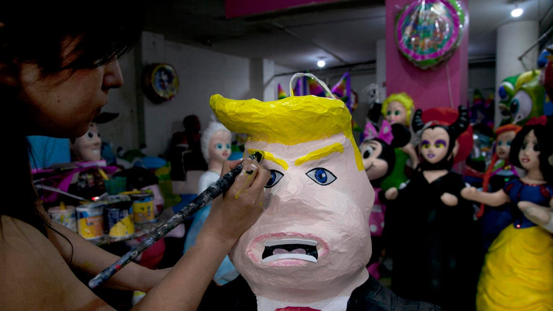 In this Friday, July 10, 2015 file photo, Alicia Lopez Fernandez paints a pinata depicting Donald Trump at her family’s store “Pinatas Mena Banbolinos” in Mexico City. (AP)