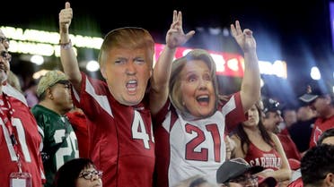 Arizona Cardinals fans with Donald Trump and Hillary Clinton masks cheer during the second half of an NFL football game against the New York Jets, Monday, Oct. 17, 2016, in Glendale, Ariz. The Cardinals won 28-3. (AP)