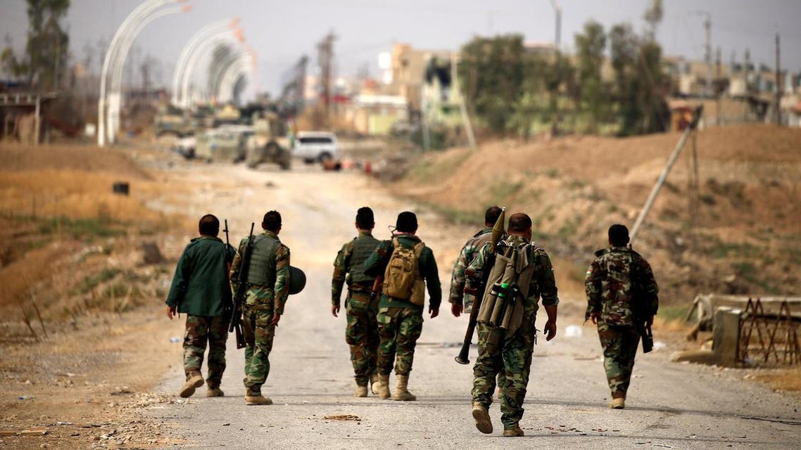 Peshmerga forces walk with their weapons in the town of Bashiqa, east of Mosul, during an operation to attack Islamic State militants in Mosul, Iraq, November 8, 2016. REUTERS