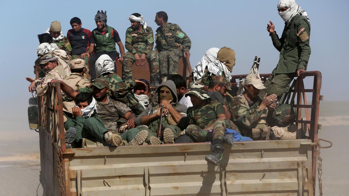 In this March 9, 2016 photo, Shiite militiamen from Popular Mobilization forces head to the front line to fight Islamic State group militants in the Samarra desert, on the border between Anbar and Salahuddin provinces in Iraq. (AP)