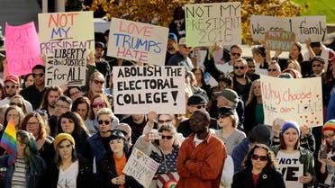 People protest against the election of President-elect Donald Trump Saturday, Nov. 12, 2016, in front of City Hall in Kansas City, Mo. Thousands took to the streets Saturday across the United States as demonstrations against Trump continued in New York, Chicago, Los Angeles and beyond. (AP)