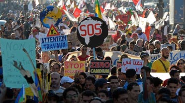 Moroccan and international demonstrator shout slogans and hold placards during a demonstration against climate change and calling for environmental action to protect the planet during a protest in Marrakesh on the sidelines of the COP22 climate conference on November 13, 2016. FADEL SENNA / AFP