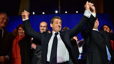 Nicolas Sarkozy (C), former French president and candidate for the right-wing Les Republicains (LR) primaries ahead of the 2017 presidential election, holds hands with party representatives at the end of a campaign meeting in Saint-Maur-des-Fosses, southeast of Paris, on November 14, 2016. CHRISTOPHE ARCHAMBAULT / AFP