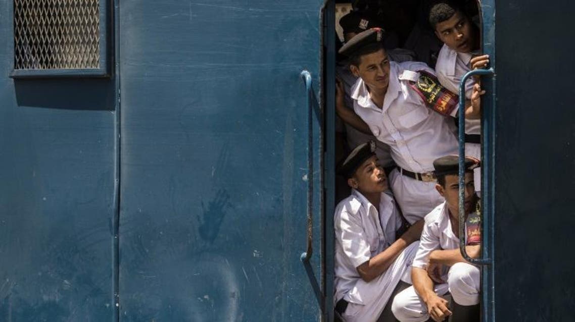 Egyptian policemen look-out from a police vehicle parked at Cairo airport on August 6, 2016. (AFP)