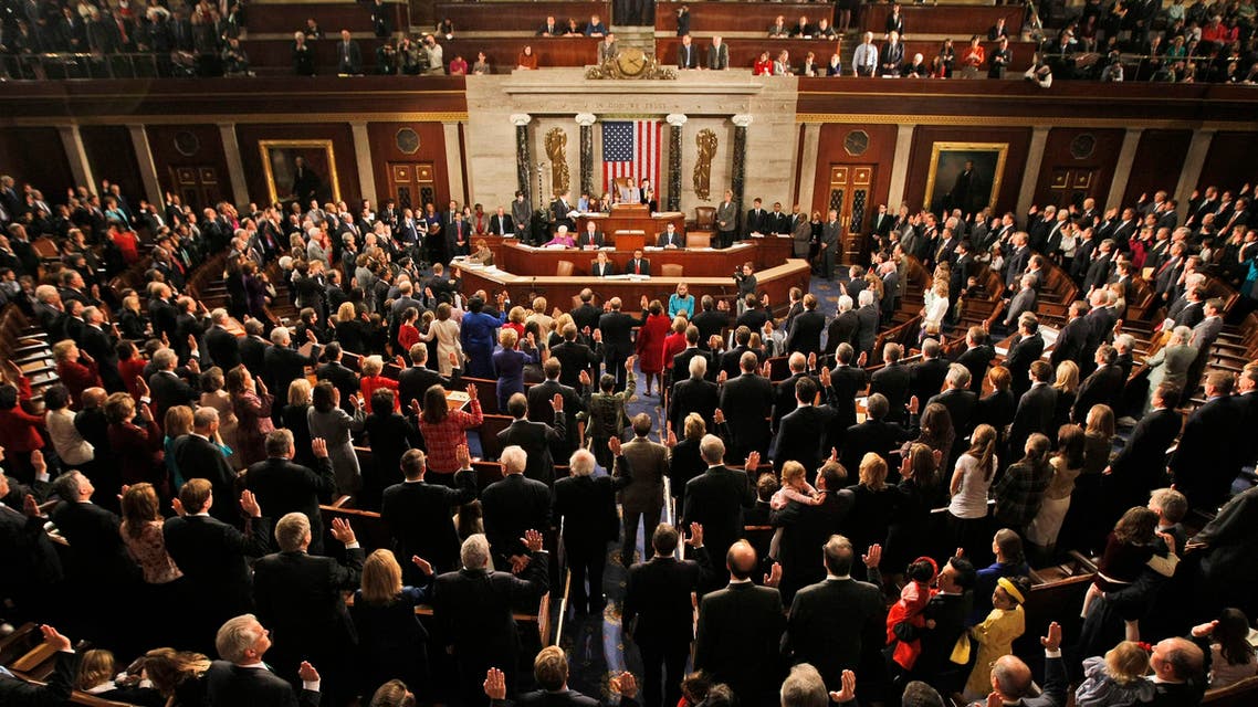 Members of the House of Representatives of the 111th Congress, accompanied by family members and guests, are sworn in in the House Chamber on Capitol Hill in Washington. (AP