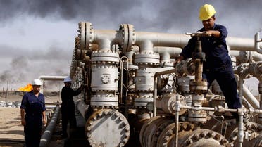 In this Dec. 13, 2009 file photo, Iraqi workers are seen at the Rumaila oil refinery, near the city of Basra, 340 miles (550 kilometers) southeast of Baghdad, Iraq. Plunging oil prices have pitched Iraq into a severe financial crisis as it struggles to combat the Islamic State group, play host to millions of refugees and rebuild cities and towns ravaged by war. With global prices hovering around $30 a barrel, Iraq has had to draw on foreign exchange reserves to fill a shortfall in the 2016 budget, which anticipated $45 per barrel. (AP