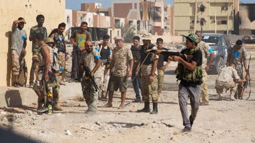 This file photo taken on October 27, 2016 shows fighters of the forces loyal to Libya's UN-backed Government of National Accord (GNA) holding a position in the coastal city of Sirte, east of the capital Tripoli, as they try to clear the last remaining Islamic State (IS) group jihadists from the al-Jiza al-Bahriya neighbourhood of the city. After a swift initial thrust on May 12, 2016 into the Islamic State group's bastion in Libya, six months on unity government forces still face dogged resistance from jihadist holdouts cornered in the Mediterranean city of Sirte.  STRINGER / AFP