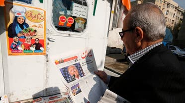 An Iranian man holds a local newspaper displaying a portrait of Donald Trump a day after his election as the new US president, in the capital Tehran, on November 10, 2016 AFP
