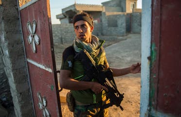 A member of forces from Iraq's elite Rapid Response Division patrols on November 19, 2016 in the village of Tall Adh-Dhahab, located some 10 kilometres (6 miles) south of Mosul.